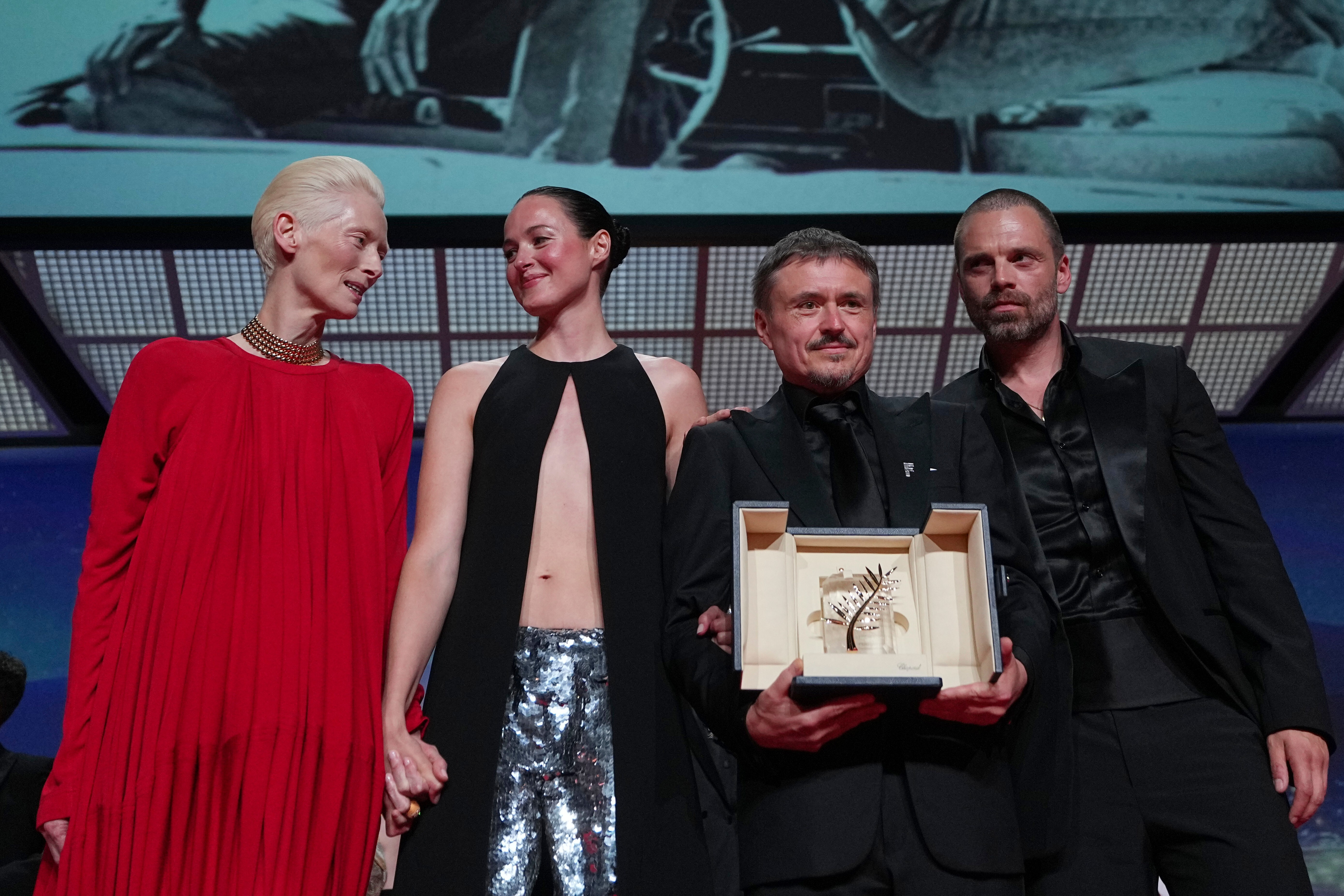 Left to right: Tilda Swinton poses with Renate Reinsve, Cristian Mungiu — winner of the Palme d